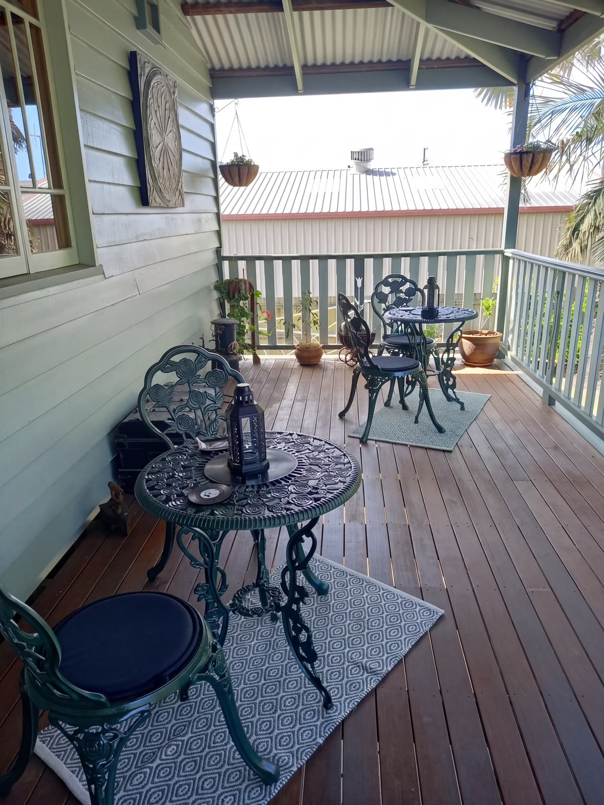 Wrought-iron bistro setting on the timber verandah — a lovely spot for breakfast