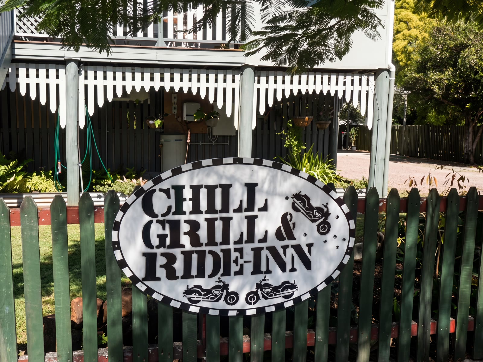 The Chill Grill & Ride Inn sign on the picket fence out the front